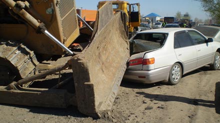 В результате падения бульдозера пострадало два автомобиля